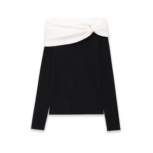 Detailed view of the gold pin accents on the off-shoulder knit top neckline