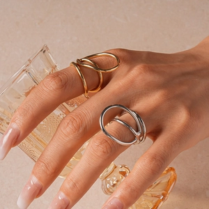 Detail view of gold and silver minimalist wavy rings with polished liquid metal finish