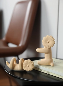 Detail of Nordic lion ceramic sculptures with matte texture on a decorative book