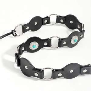 Close-up of black leather waist chain with silver studs and turquoise stone accents