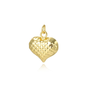 Macro shot of gold hollow heart pendant showing textured 18k plated copper finish