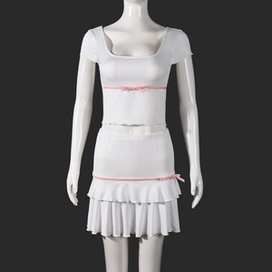 Detail of white short-sleeve top and ruffled skirt set with pink ribbon bows