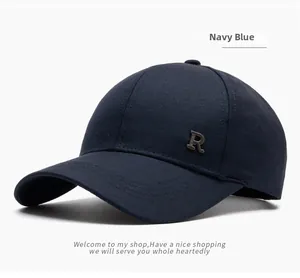 Detail of navy blue cotton baseball cap showing metallic R logo and side stitching