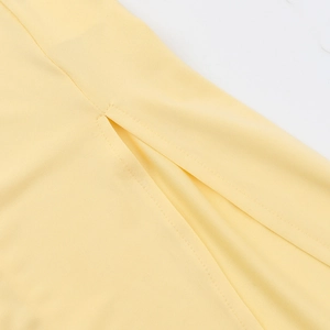 Detailed view of the side slit design and high-quality fabric texture on a yellow dress