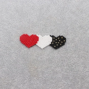 Detail of Miyuki seed bead heart charms in red white and black for jewelry making