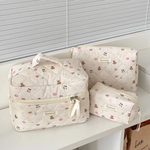 Detailed set of quilted donut bear cosmetic bags with handles and sturdy zippers