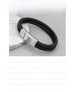 Detailed view of black woven leather bracelet with polished stainless steel magnetic clasp
