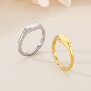 Detailed view of two polished minimalist geometric rings in gold and silver finishes