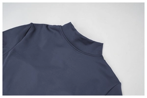 Detail of the mock neck collar with fine stitching on the dark blue yoga jumpsuit