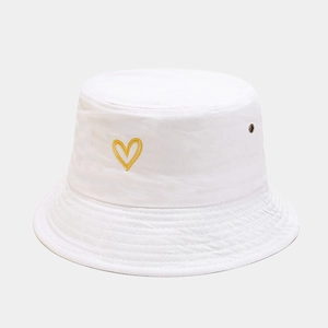 Detail of yellow heart embroidery on a white cotton canvas bucket hat with eyelets