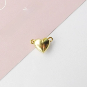 Detail view of heart-shaped magnetic clasp in gold finish for DIY jewelry connectors