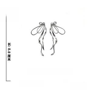 Detail showing bow ribbon earrings dimensions of 8.8cm length with silver needles