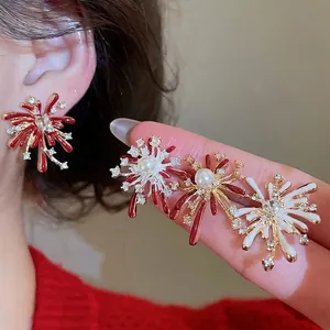 Elegant gold fireworks stud earrings with colorful enamel petals and faux pearl center