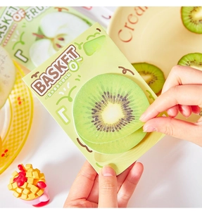 Macro shot of realistic kiwi fruit shaped sticky notes being peeled from the fruit basket