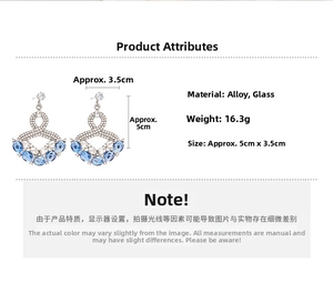 Detail view of fan-shaped drop earrings with blue glass stones and 5cm size dimensions