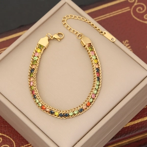 Macro detail of gold plated bracelet with multi-colored crystals and 18K hallmark tag