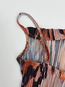 Detail showing vertical pleated texture and adjustable shoulder straps on the top