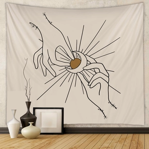 Detail of bohemian sun and moon tapestry on wall with minimalist black line art style