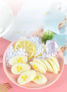 Detailed macro view of realistic PVC banana slices on a decorative pink plate