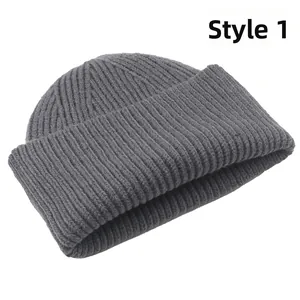 Detail showing the thick vertical knit texture and warm cuff of the grey beanie