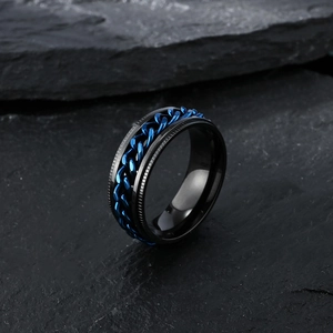 Close-up of black titanium steel ring featuring a rotatable blue center chain and gear edges