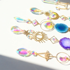 Close-up of golden suncatchers featuring natural agate slices and crystal prisms
