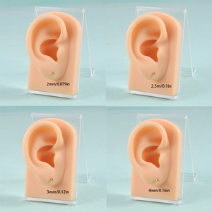 Size comparison chart showing 2mm to 4mm gold ball stud earrings on model ears