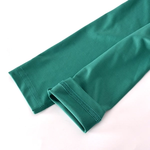 Detailed close-up of green elastic knit fabric sleeves with double-stitched flat seams