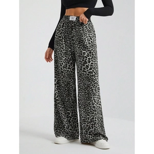 Detail of high waist elastic band on leopard print wide leg trousers with drape effect