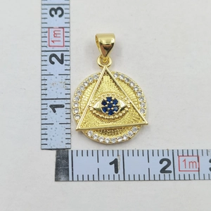 Detail of gold Evil Eye pendant showing dimensions of 2.5cm width with blue zircon stones