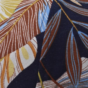 Macro view of cotton baseball cap fabric with tropical palm leaf print and fine stitching