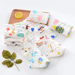 Close-up of six-layer cotton muslin towel showing bubble texture and cartoon prints