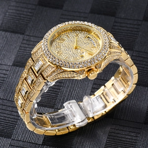 Macro side view of gold diamond-encrusted business watch with day-date display