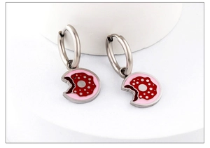Detail view of pink donut pendant earrings with silver hoops and enamel finish
