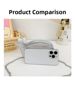 Size comparison of silver dolphin mini bag next to a smartphone showing compact dimensions