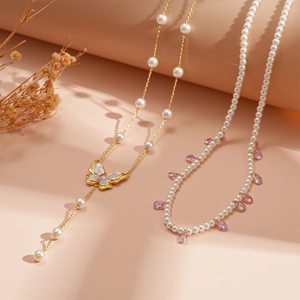 Elegant butterfly pearl necklace with crystal teardrop pendant in luxurious gold finish