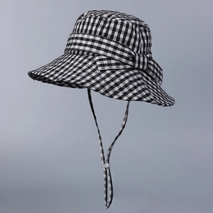 Classic black and white checkered sun hat with a side bow and adjustable drawstring