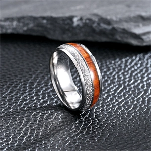 Close-up of a retro titanium steel ring with wood and meteorite pattern inlay