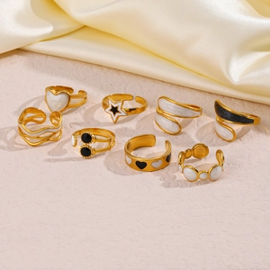 Golden stainless steel ring set with white and black enamel stars and hearts