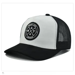 Detail view of the breathable mesh back and circular patch on the suede trucker hat