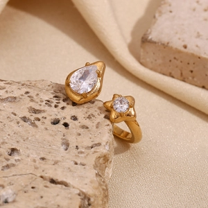 Detail of 18K gold plated open ring featuring teardrop and star zircon stones
