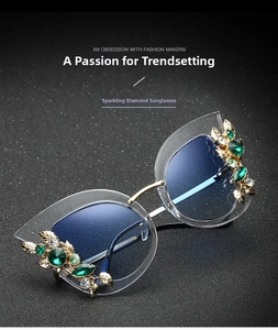 Detail of cat eye sunglasses with emerald leaf crystals and blue gradient lenses