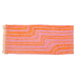Macro view of wave patterns and soft tassel fringe on orange and pink knit scarf