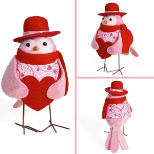 Detailed multi-angle view of a pink bird plush ornament with red heart and winter accessories