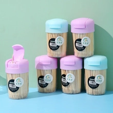 Detail showing portable transparent toothpick dispensers with colorful flip lids and refills