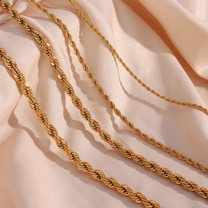 Detailed macro view showing different sizes of gold-plated stainless steel rope chains