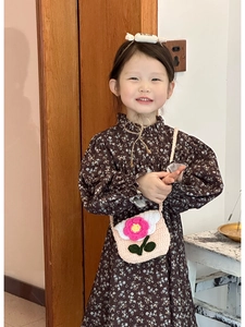 Detail of crochet flower shoulder bag paired with floral vintage dress for kids