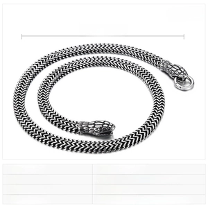 Close-up of vintage punk snake chain necklace with double snake heads in stainless steel