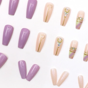 Aurora taro purple press-on nails with glitter gradients and rhinestone accents in long coffin shape