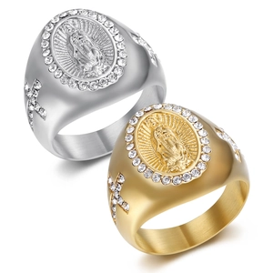 Detail of gold and silver plated Virgin Mary signet rings with cubic zirconia stones